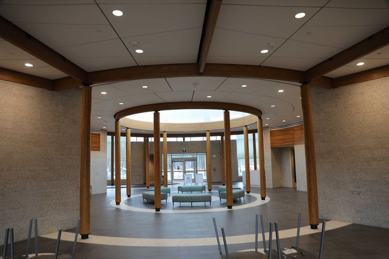 A large room with a circular ceiling and wooden pillars