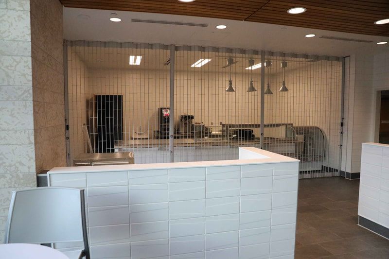 A room with a fence and a counter in it.