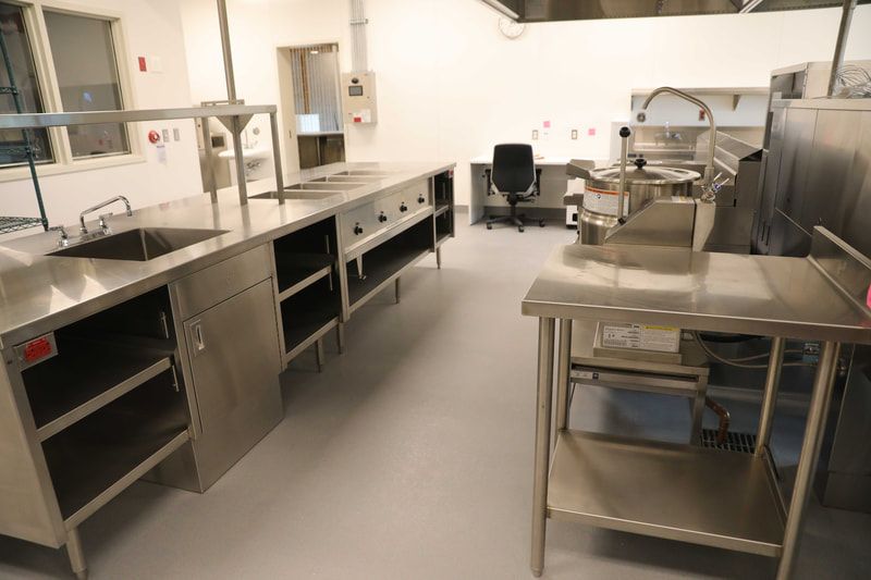 A kitchen with stainless steel appliances and a sink.