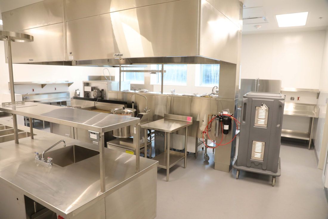 A kitchen with stainless steel appliances and a sink.