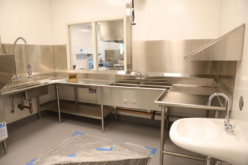 A kitchen with stainless steel appliances and a sink.