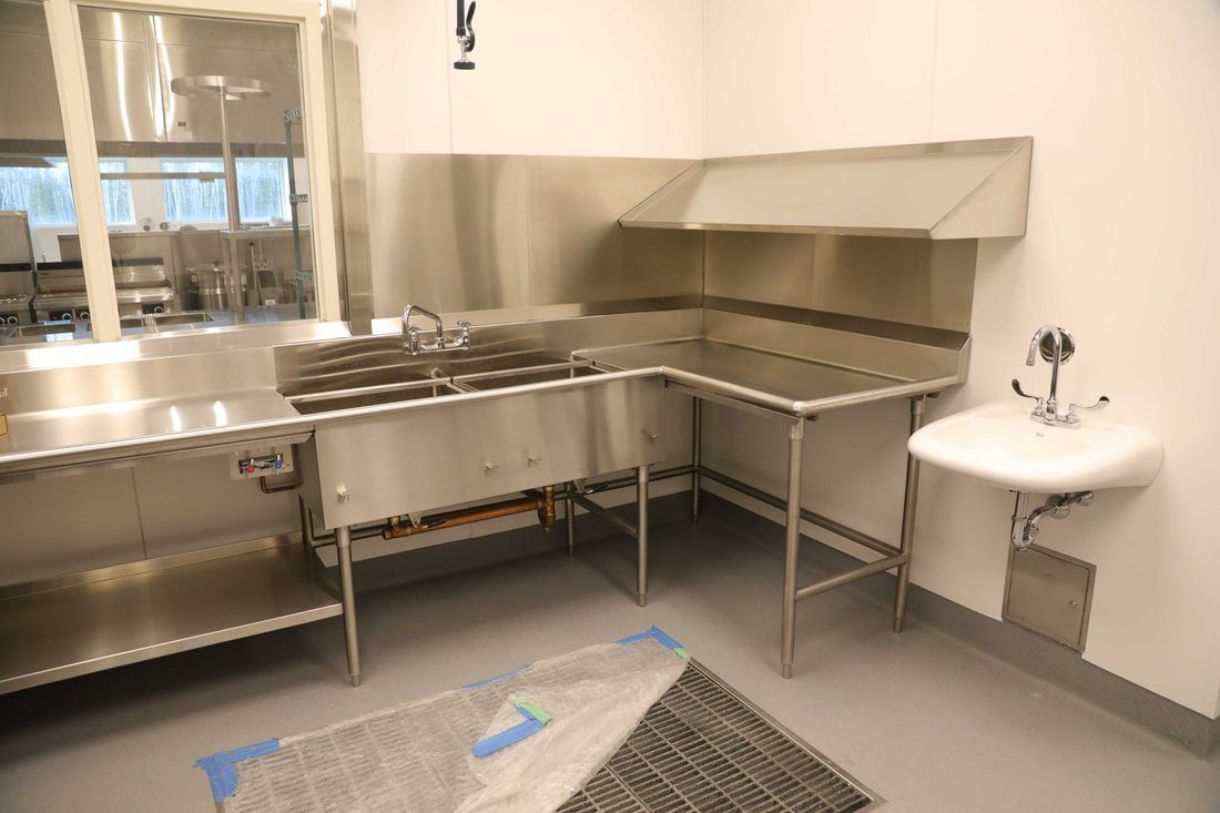 A kitchen with stainless steel appliances and a sink.