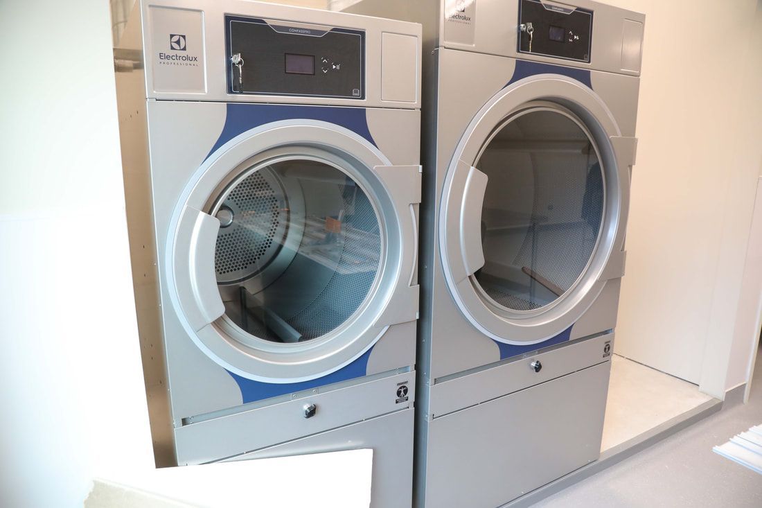 A washer and dryer are sitting next to each other in a laundry room.