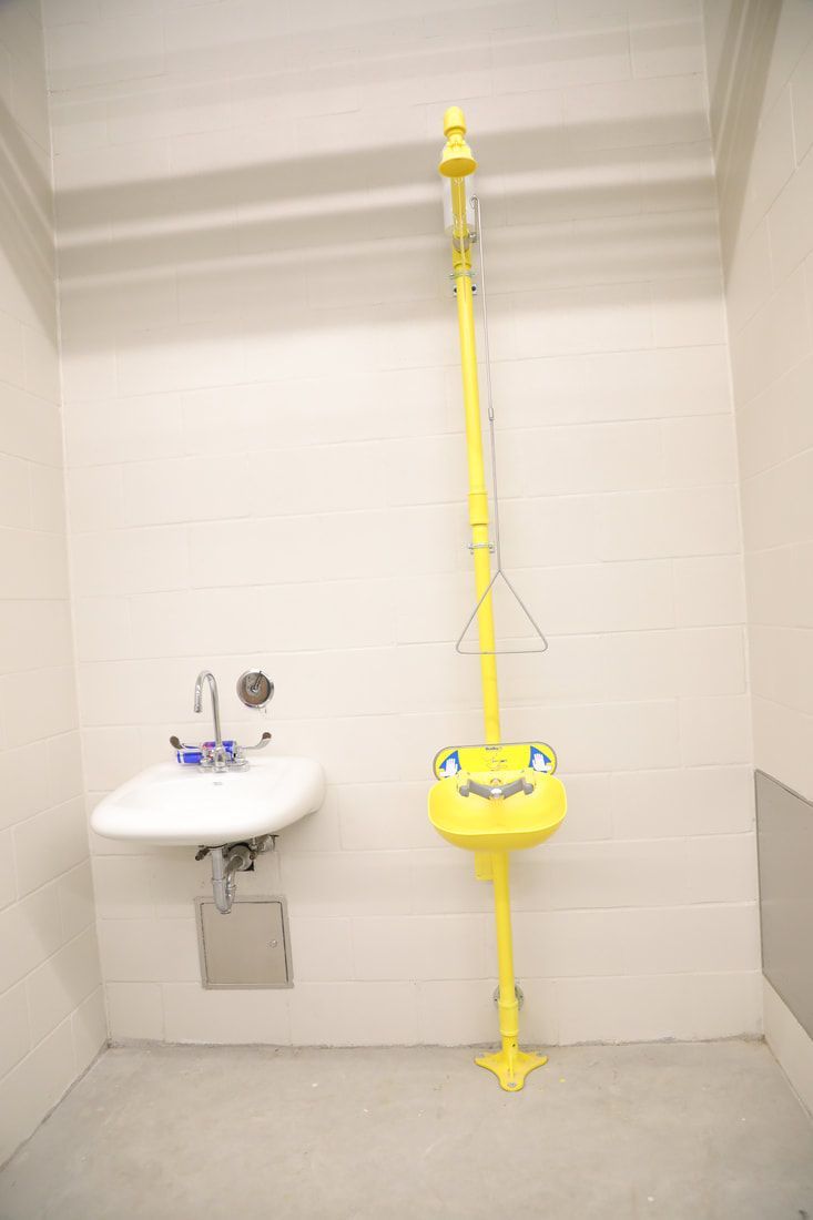 A bathroom with a sink and a yellow sink.