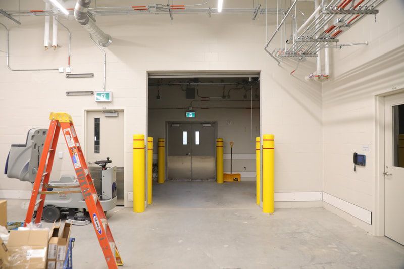 An empty room with a ladder in the middle of it