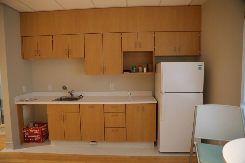 A kitchen with wooden cabinets and a white refrigerator
