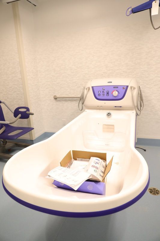 A bathroom with a bathtub and a box that says usm on it