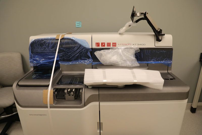A machine is wrapped in plastic and is sitting on a counter.