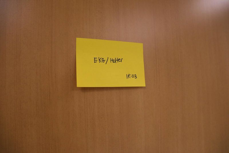 A yellow sticky note on a wooden door says english hacker