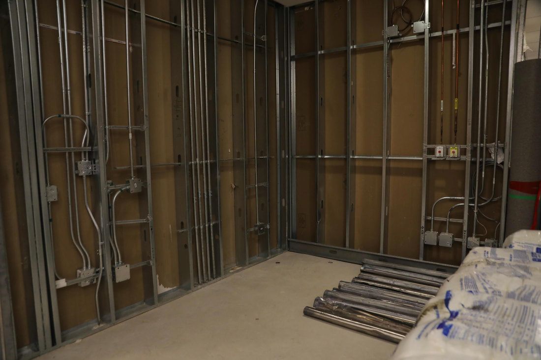 A room with a lot of metal frames on the walls.