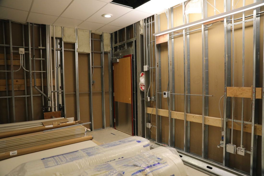 A room with a lot of metal frames on the walls and ceiling.
