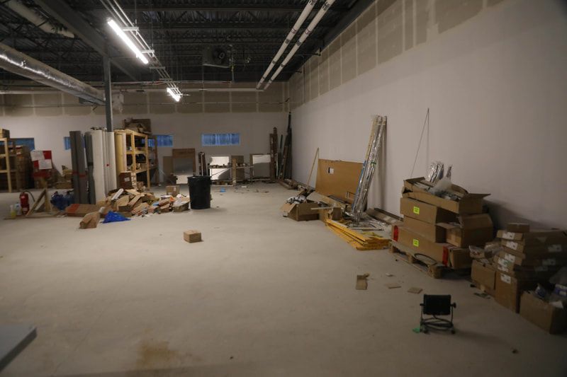 A large empty room with a lot of boxes on the floor.