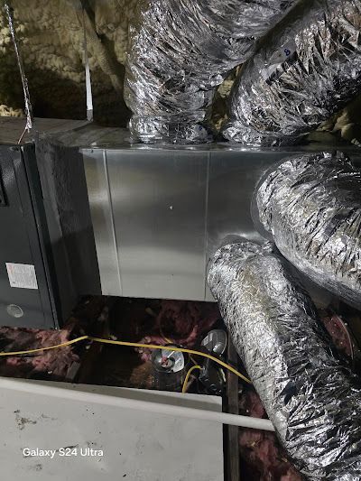 A bunch of ducts are hanging from the ceiling of a room.