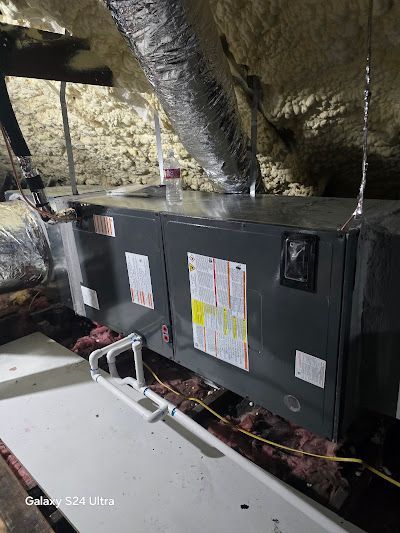 An air conditioner is installed in the attic of a house.