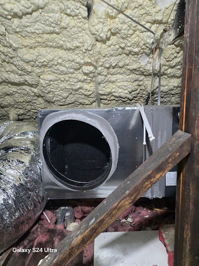 A ventilation system is installed in the attic of a house.