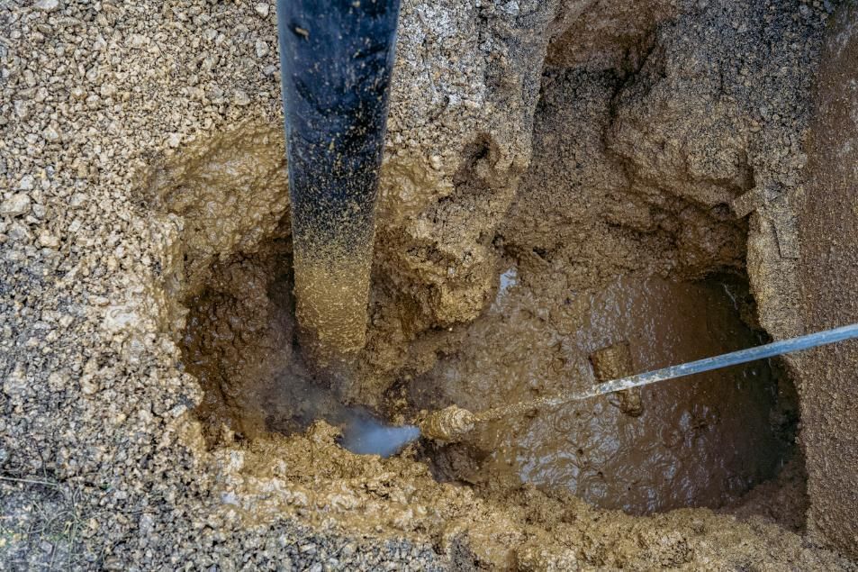 Digging A Hole In The Ground With A Shovel — Porta-Vac in Bowen, QLD