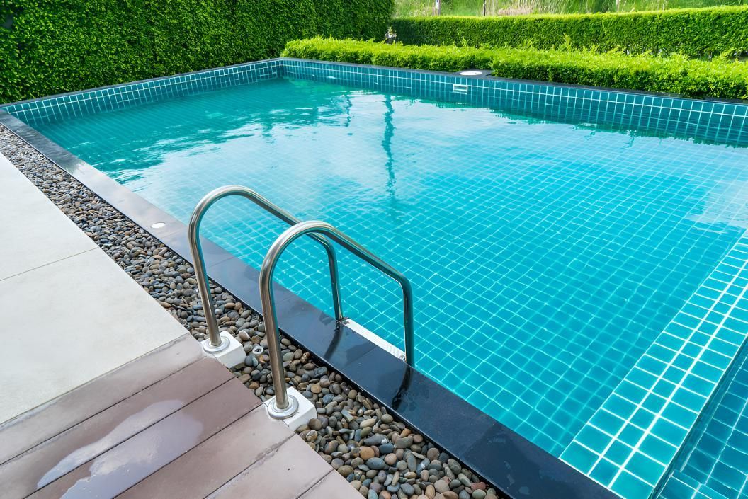 A Large Swimming Pool With Stairs Leading Into It — Porta-Vac in Bowen, QLD