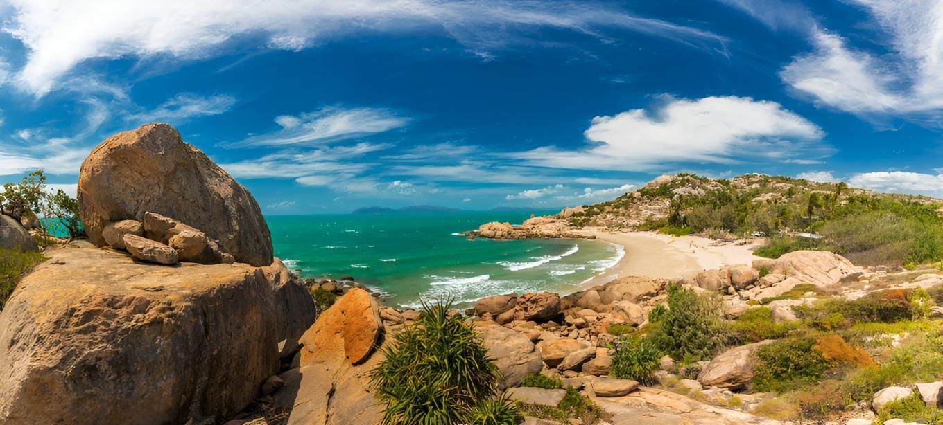 A Panoramic View Of A Beach With A Large Rock In The Foreground — Porta-Vac in Bowen, QLD