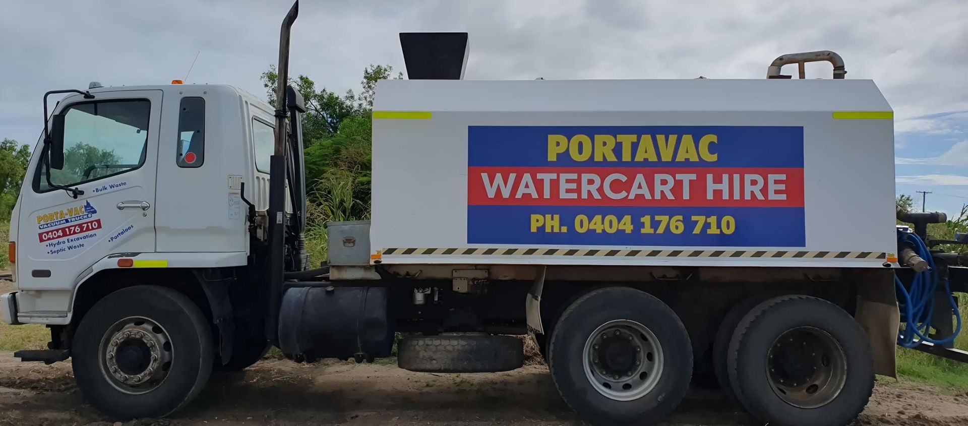 A Portavac Water Cart Hire Truck is Parked in the Dirt — Porta-Vac in Moranbah, QLD