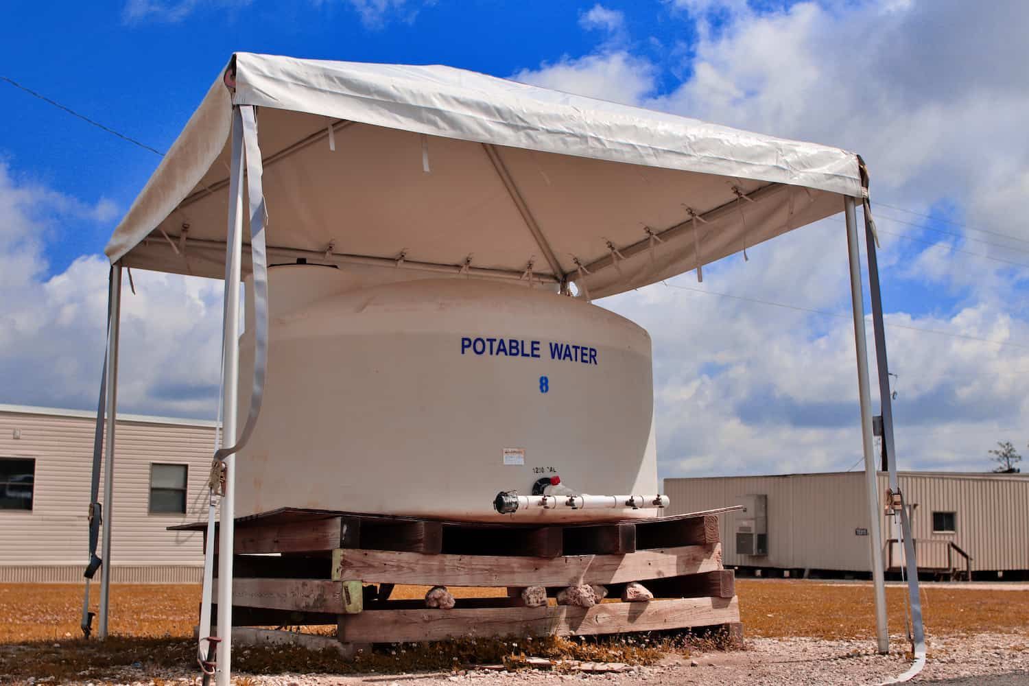A Portable Water Tank Is Under A White Tent — Porta-Vac in Proserpine, QLD