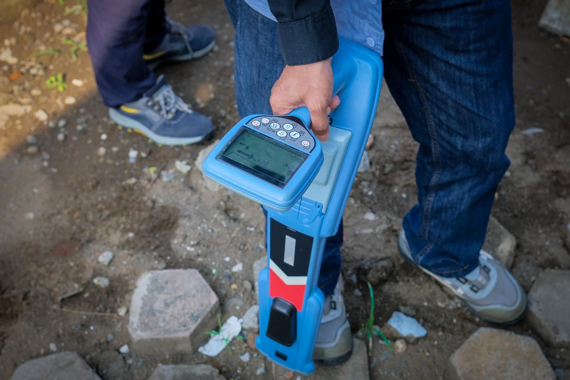 A Person Is Holding A Blue Device In Their Hand — Porta-Vac in Bowen, QLD