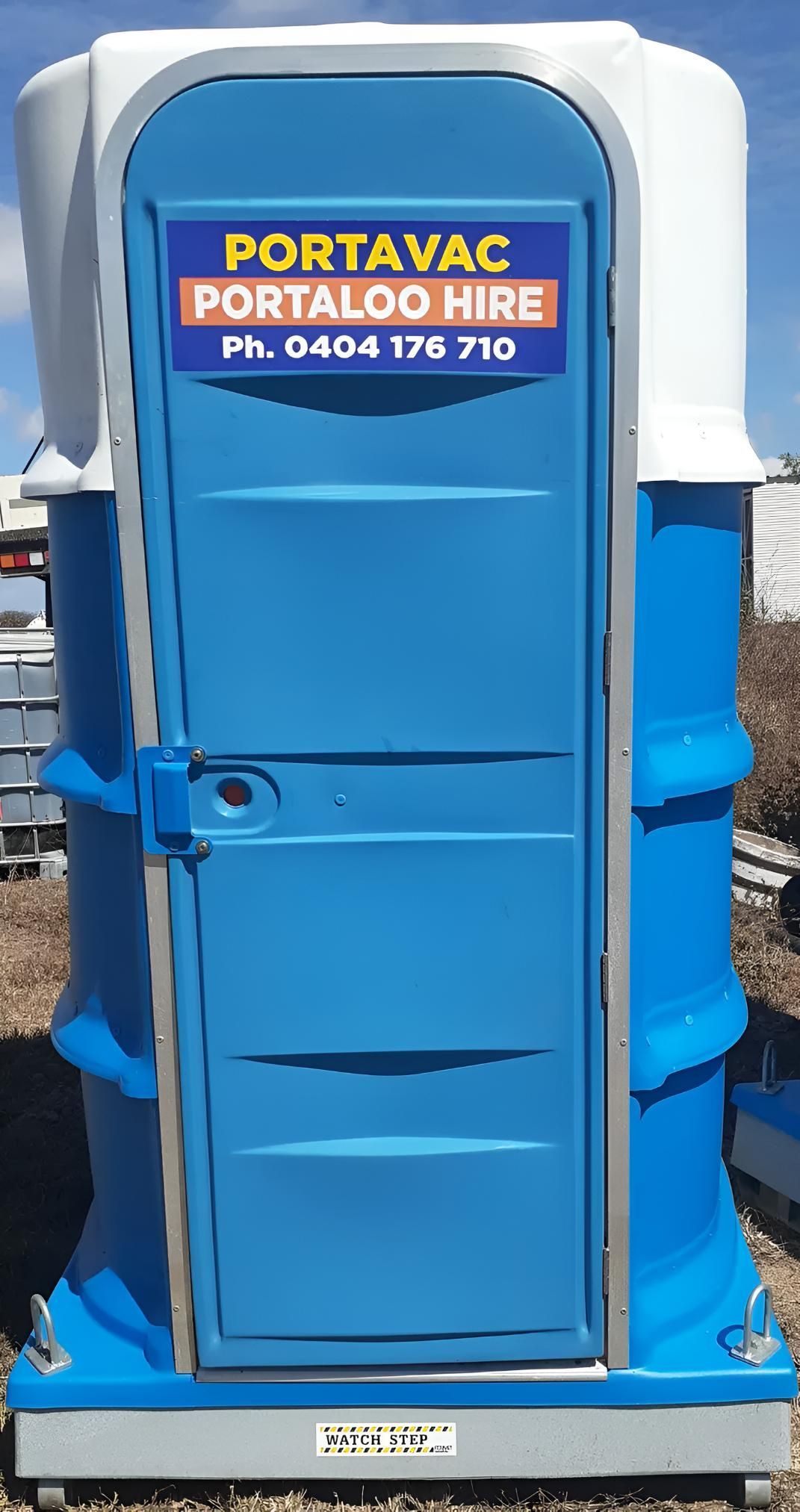 A Blue Portavac Portaloo Hire Toilet Is Sitting On The Ground — Porta-Vac in Bowen, QLD