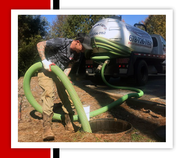 Men Inspecting The Sewage — Statham, GA — Affordable Septic Service Man using green hose to service a septic tank; truck in the background.