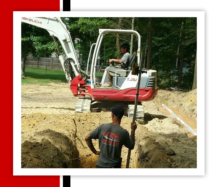 Men Digging For A Trench — Statham, GA — Affordable Septic Service Two workers on a construction site; one operates a small excavator while the other stands in a trench holding a pole.