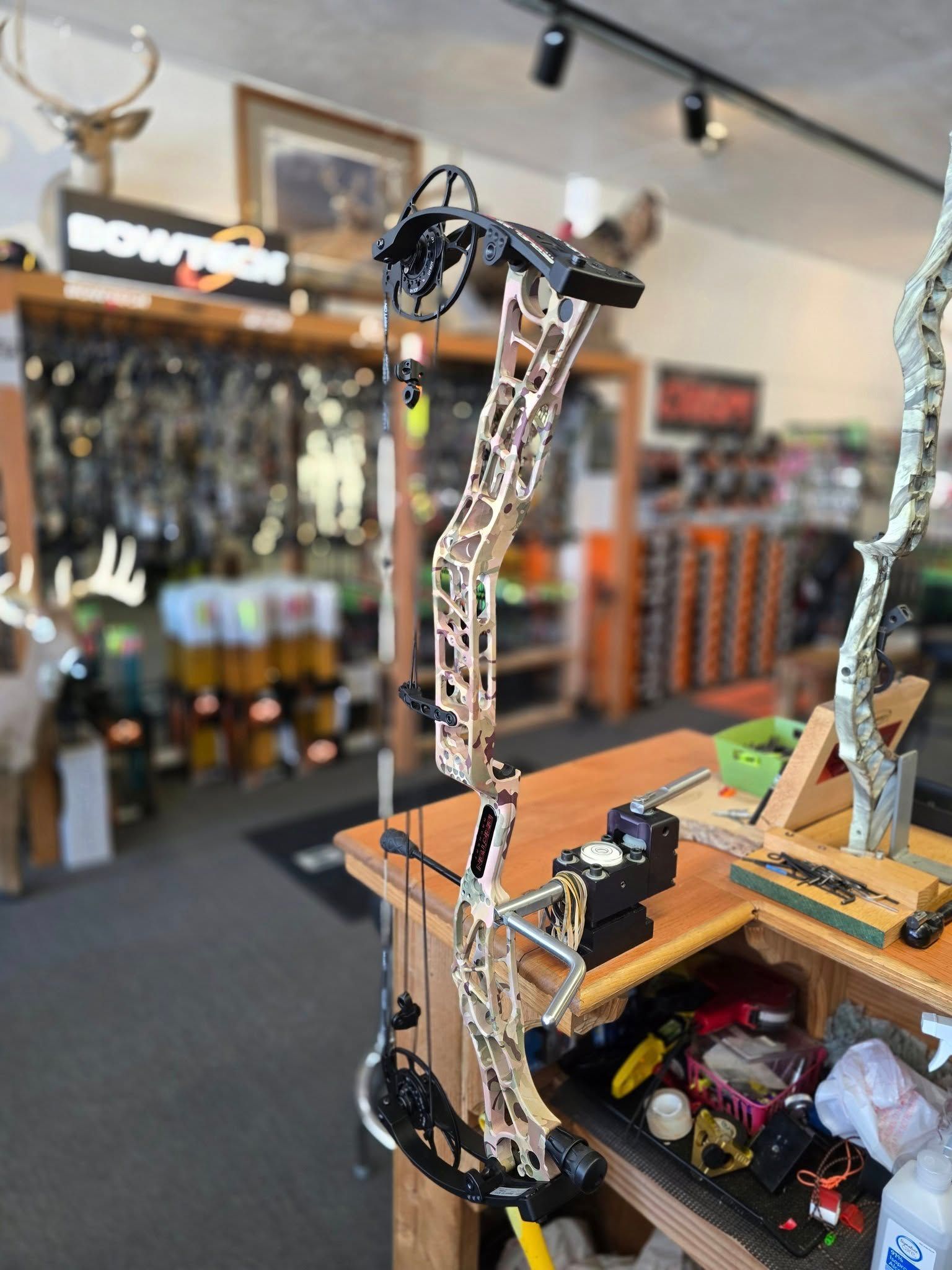 Close-up of a mounted bow with an arrow in a sports shop display