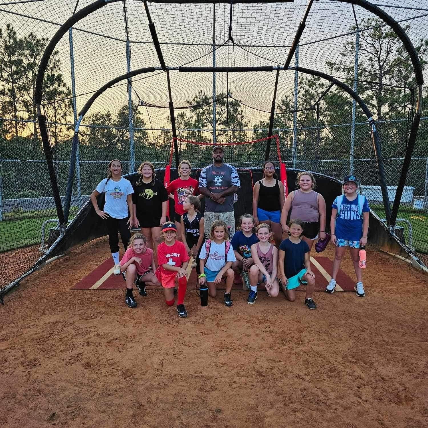 Foundry Athletics athletes gathered in a training cage