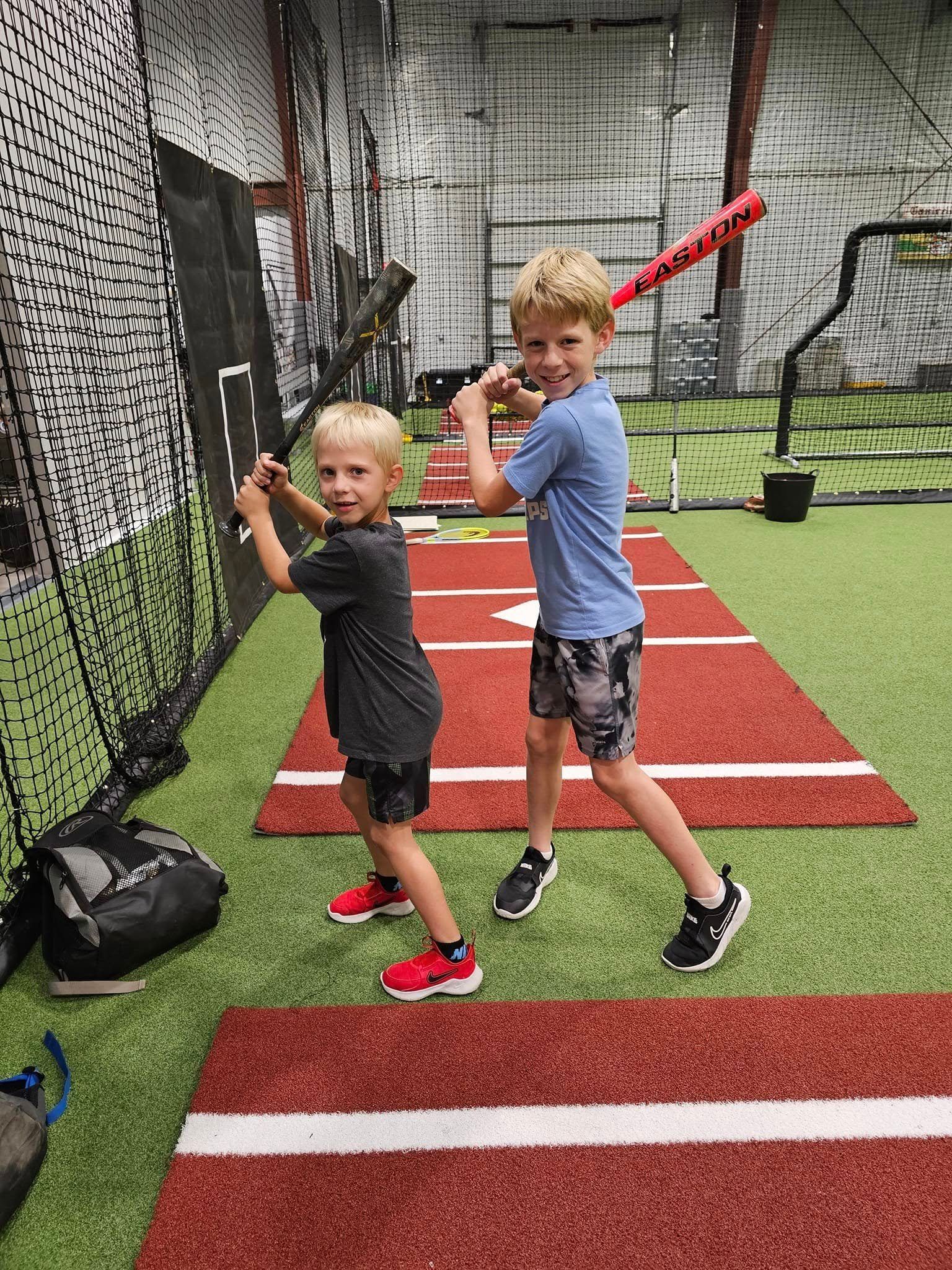 Young athletes practicing baseball inside Foundry Athletics