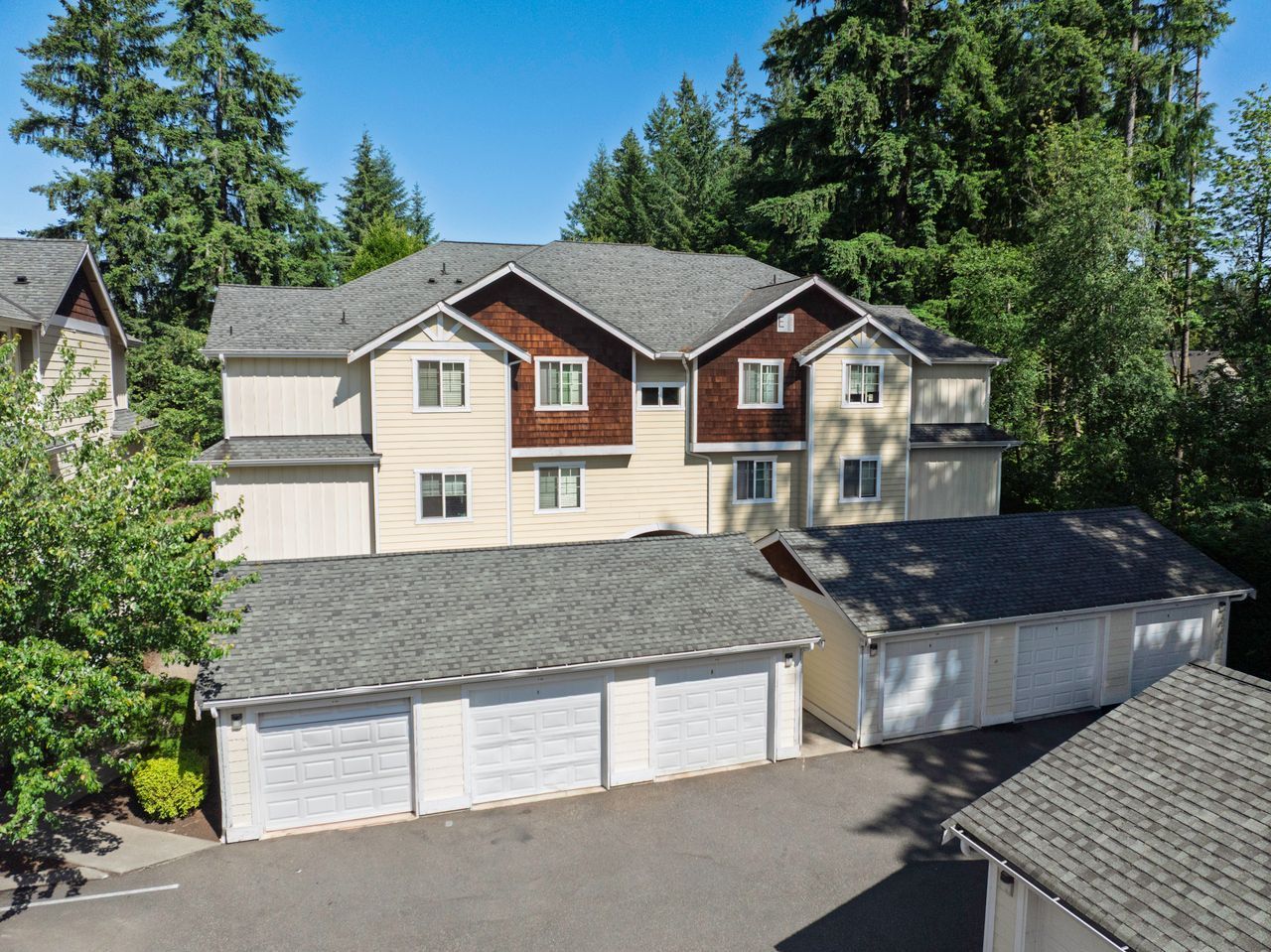 Photo of an apartment building with garages in back of it