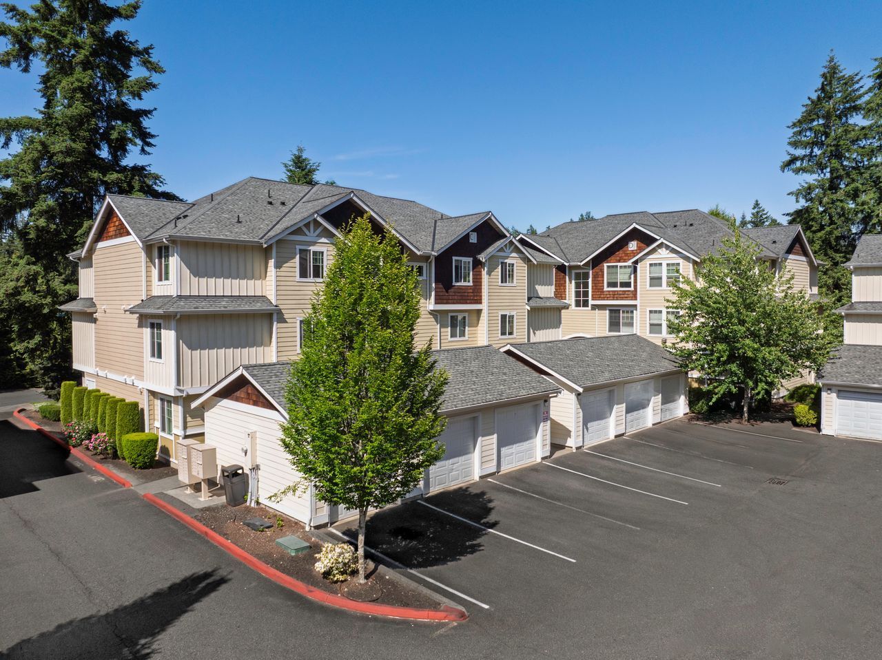 Photo of a couple of buildings with the garages in front of them and parking spaces in front of the garages