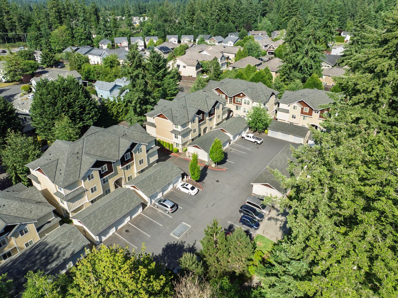 Photo of an apartment building complex with plenty of trees surrounding