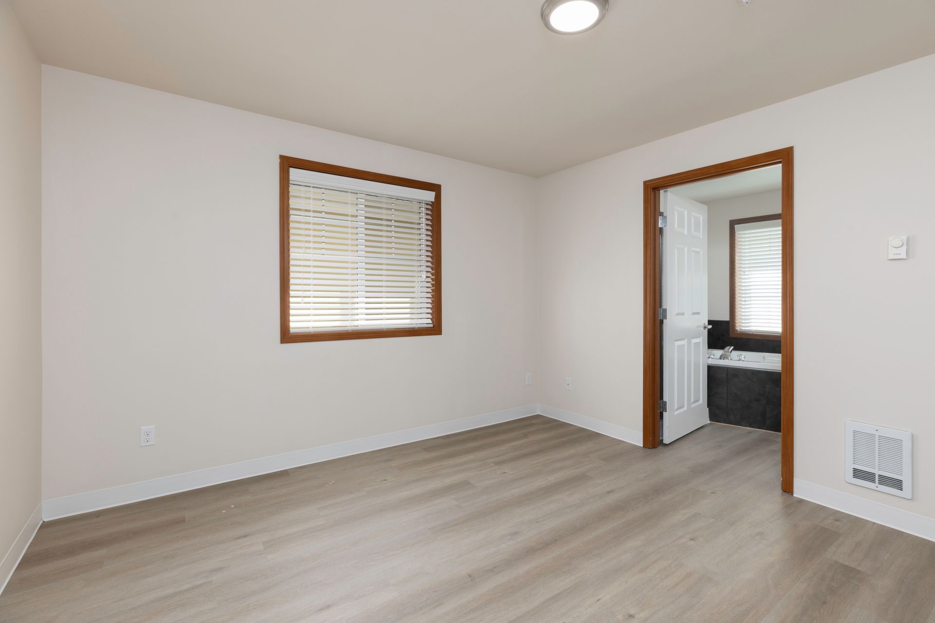 Photo of a master bedroom showing the entrance to the bathroom