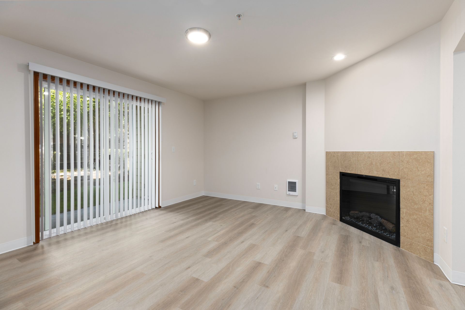 Photo of a living room with plenty of natural lighting and a fireplace