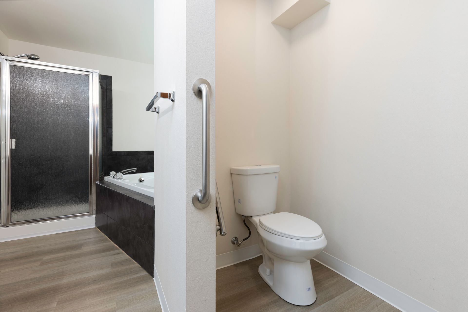Photo of a bathroom with a toilet in the foreground