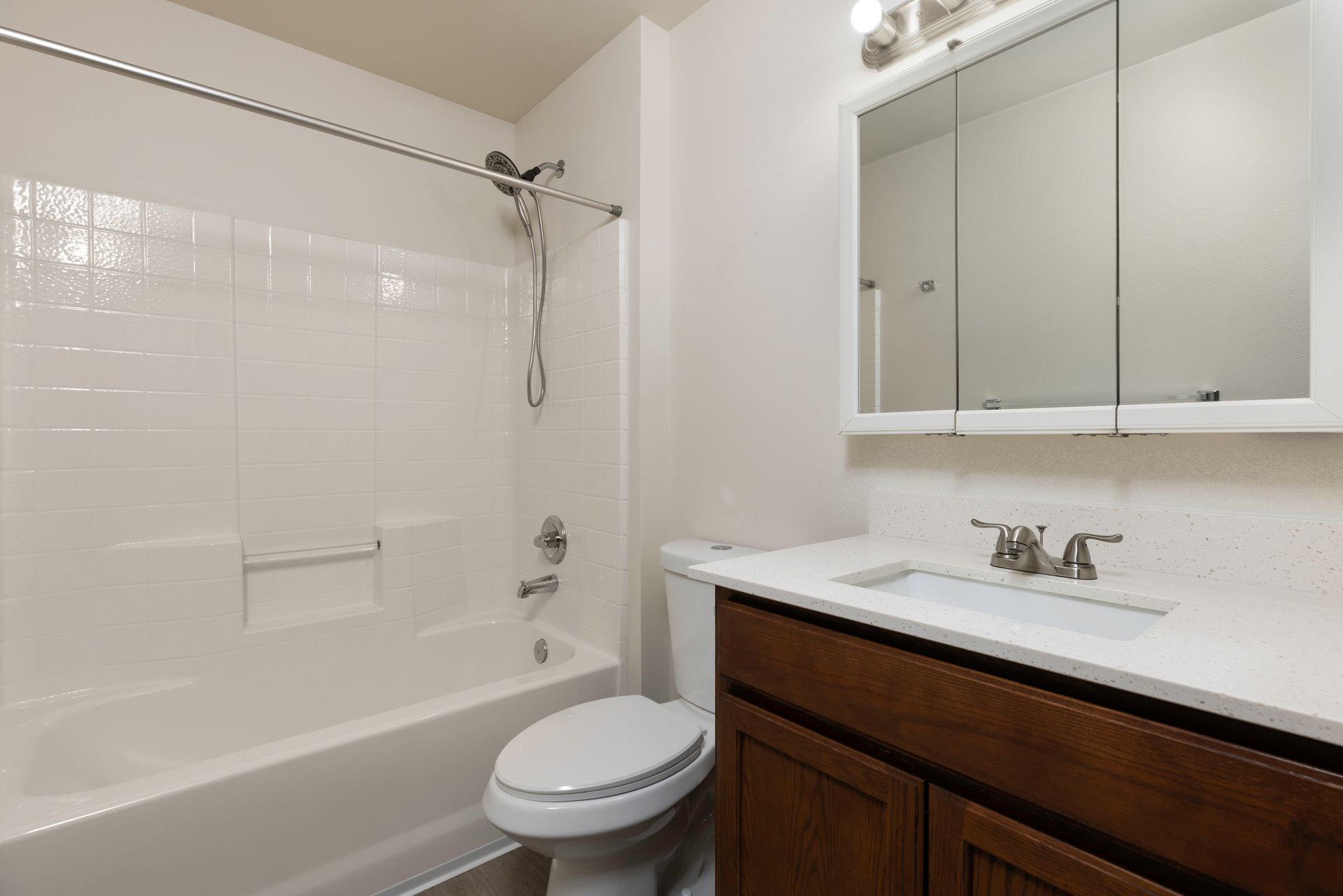 Photo of a bedroom with a bathtub/shower combo