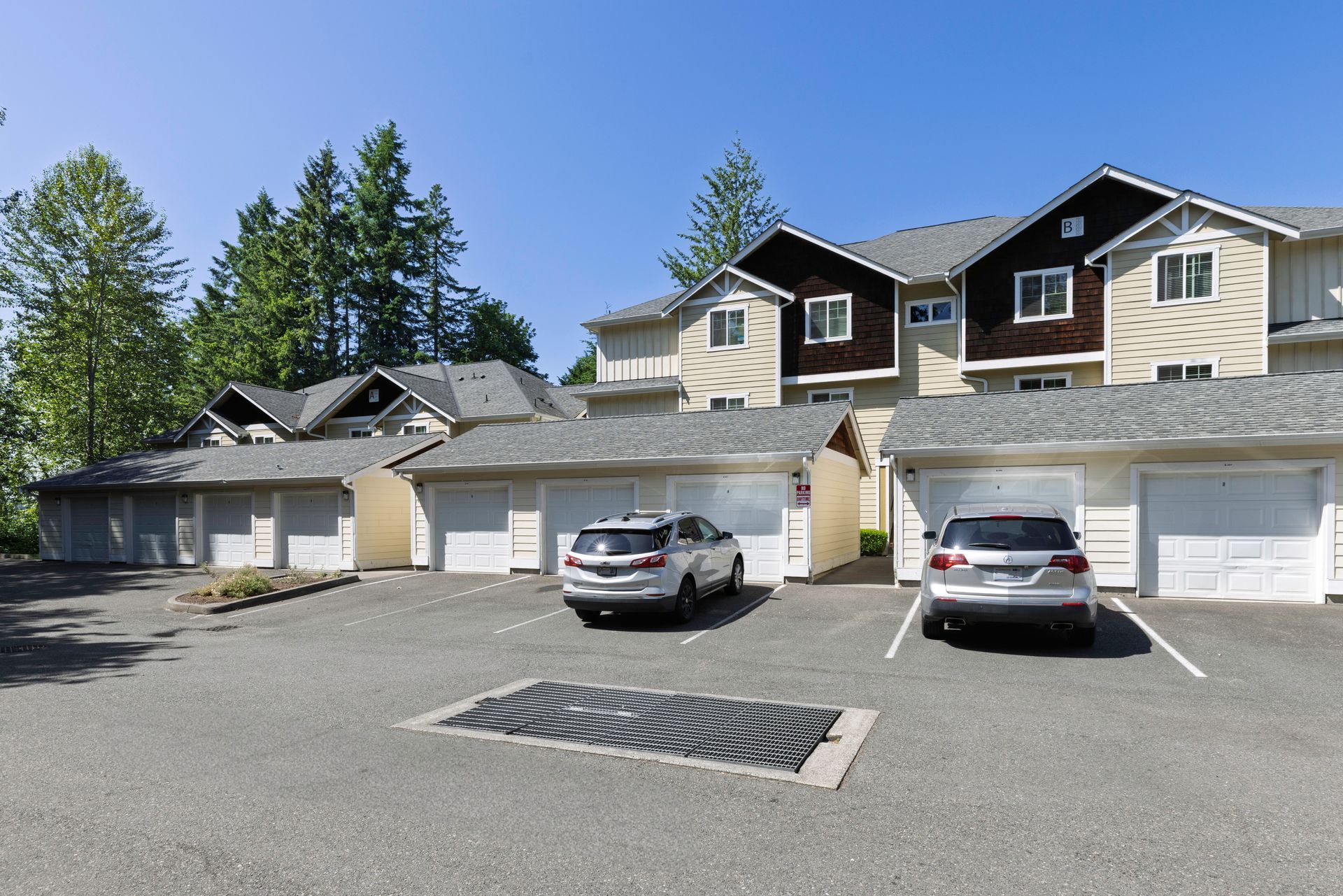 Photo of a parking lot showing parking spaces and garages