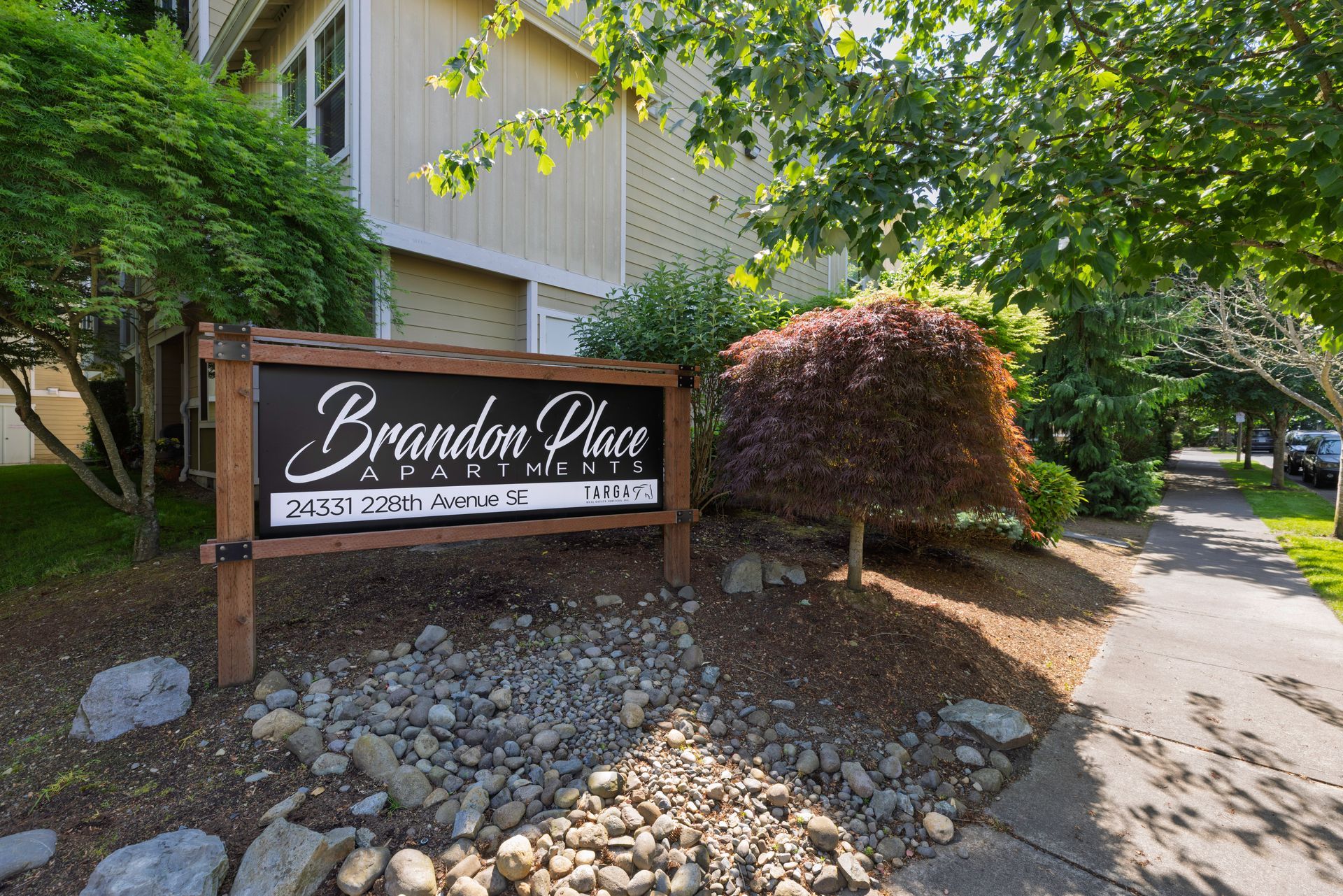Photo of a entrance sign showing the name of the apartments