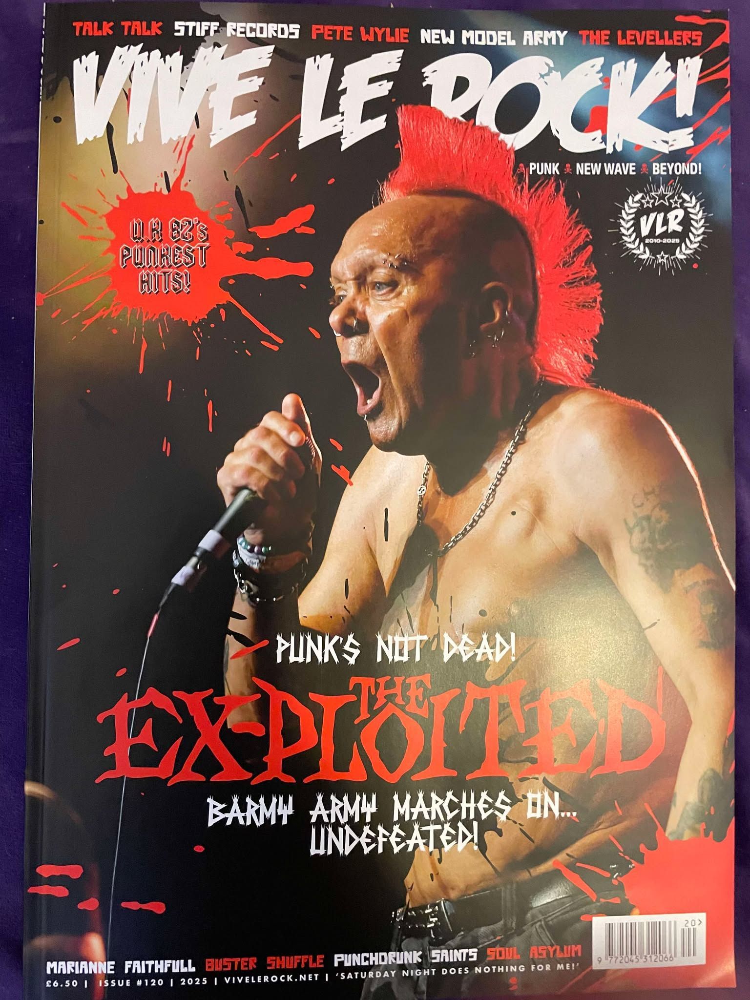 A man singing into a microphone on the cover of a magazine