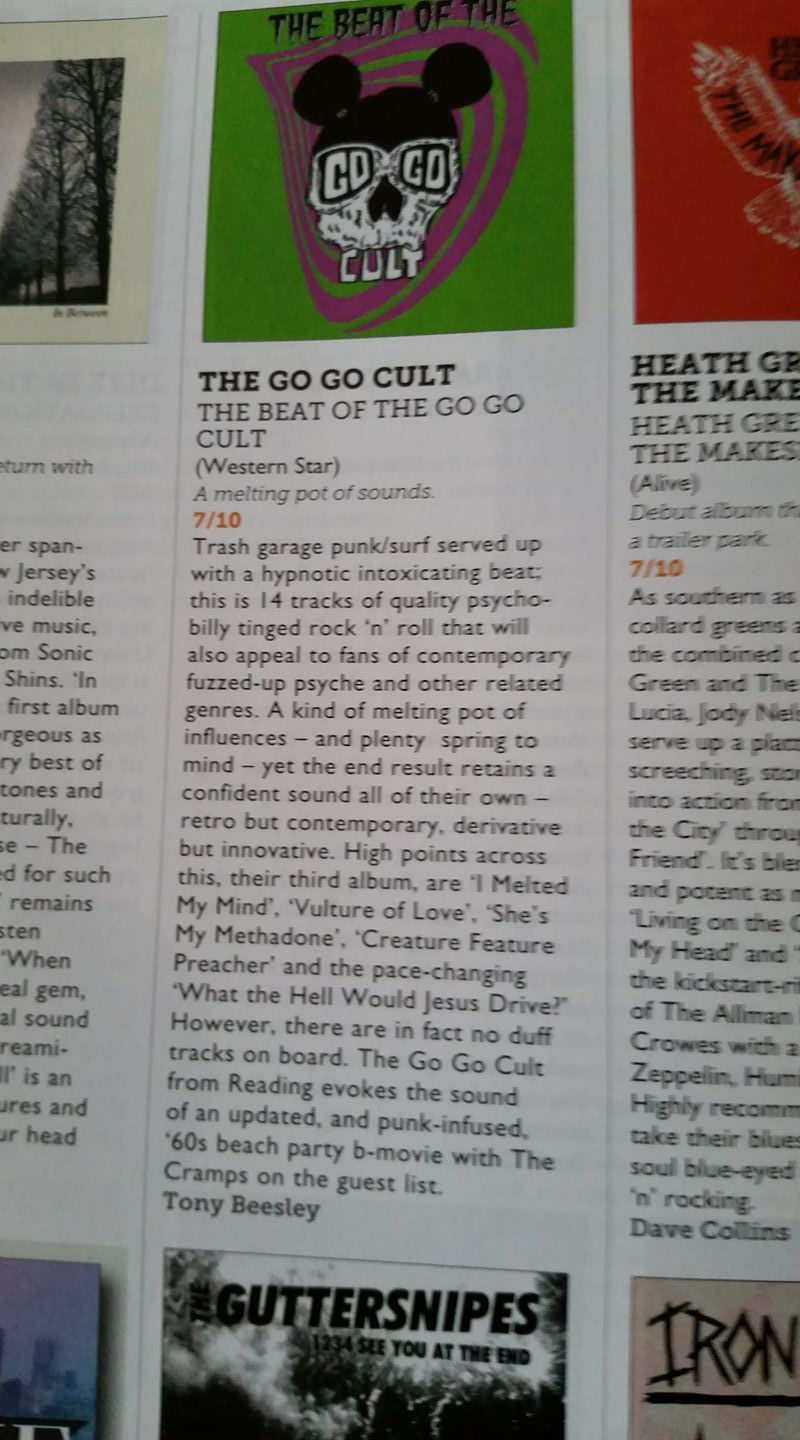 A magazine is open to a page that says the go go cult