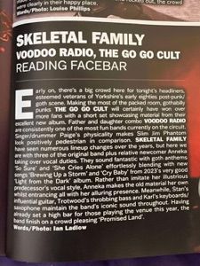 A magazine is open to a page that says ' skeletal family voodoo radio the go go cult reading facebar '