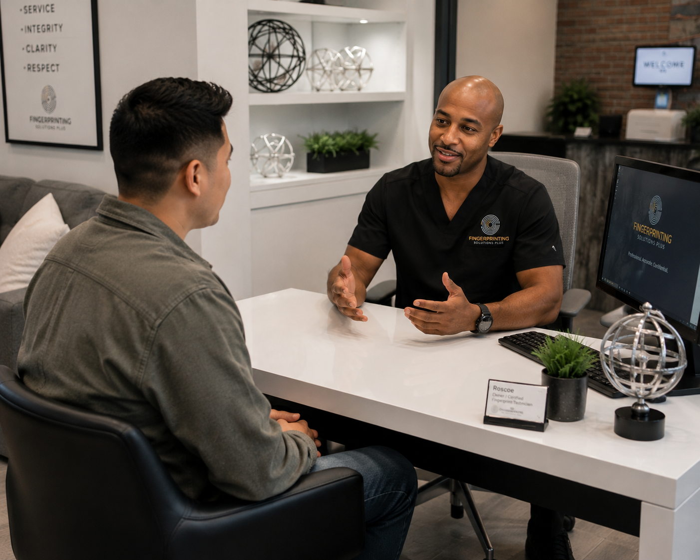 Fingerprint technician calmly explaining the fingerprinting process to a client in a welcoming office environment