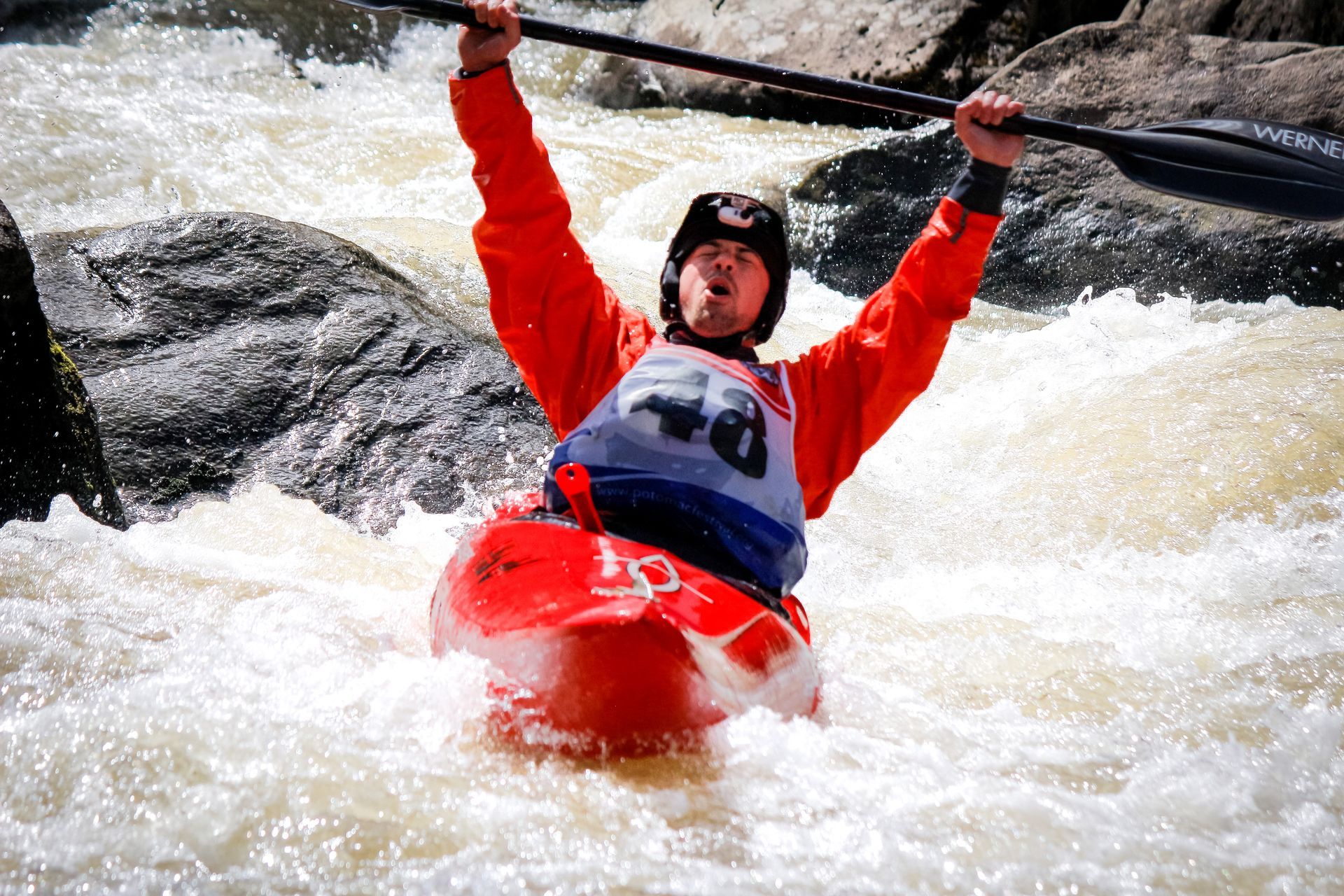 Garrett Scott crossing extreme kayaking race finish line