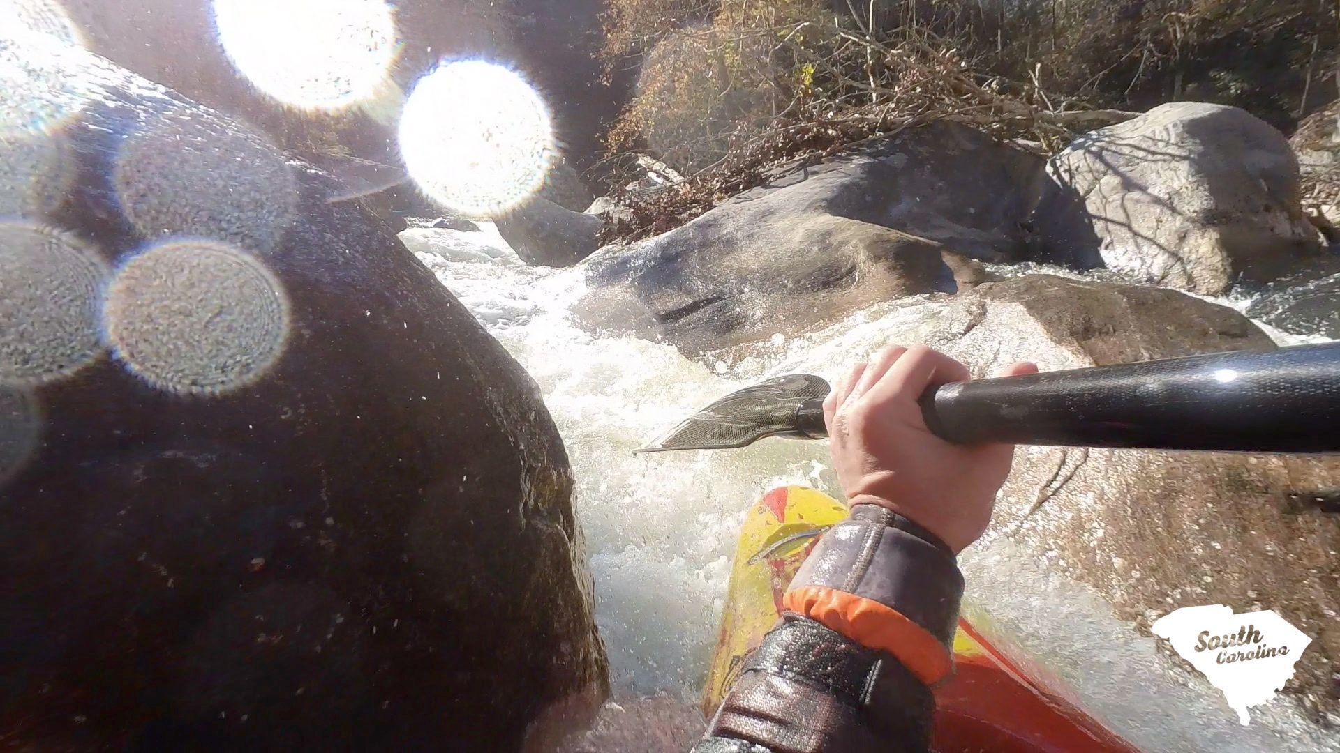 Garrett paddling through a narrow slot in the river