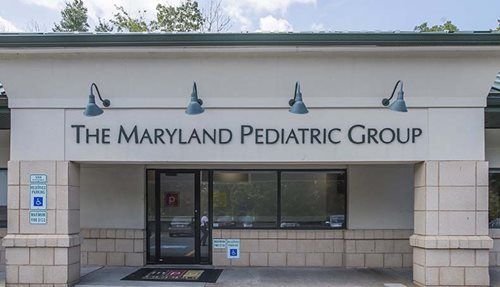 The Maryland Pediatric Group storefront with blue awnings and a glass entrance