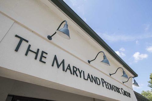 Entrance sign for The Maryland Food Bank under blue awning lights