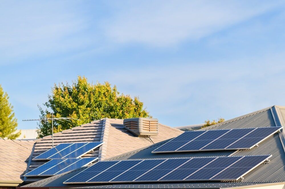 There Are Many Solar Panels On The Roof Of A House — Homeland Electrical & Refrigeration In Braitling, NT
