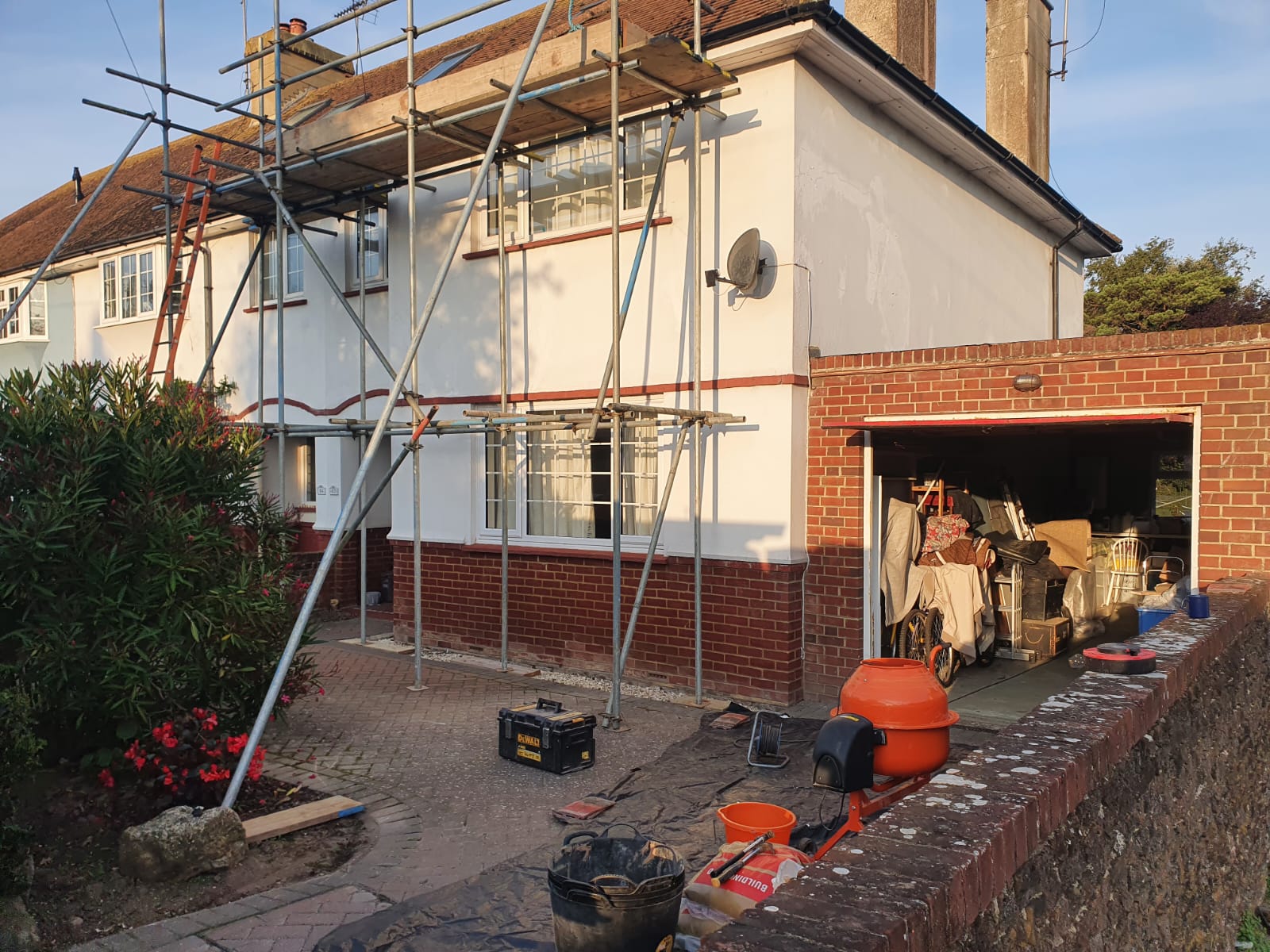 a house is being remodeled with scaffolding on the side of it .